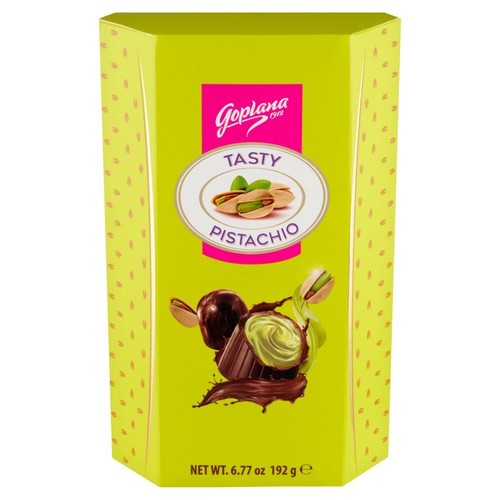 Jasnozielone, kartonowe opakowanie czekoladek Goplana Smakowite Pistacjowe, waga 192 g. Na etykiecie widnieje nazwa produktu, grafika przedstawiająca pistacje w łupinach i bez, a także czekoladki z pistacjowym nadzieniem i polewą czekoladową.
