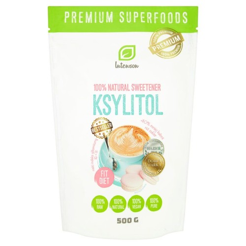 Intenson Ksylitol, 100% naturalny słodzik w białej torebce 500g. Opakowanie z zielonymi akcentami, przedstawia filiżankę kawy i makaroniki. Produkt jest surowy, naturalny, wegański i czysty.