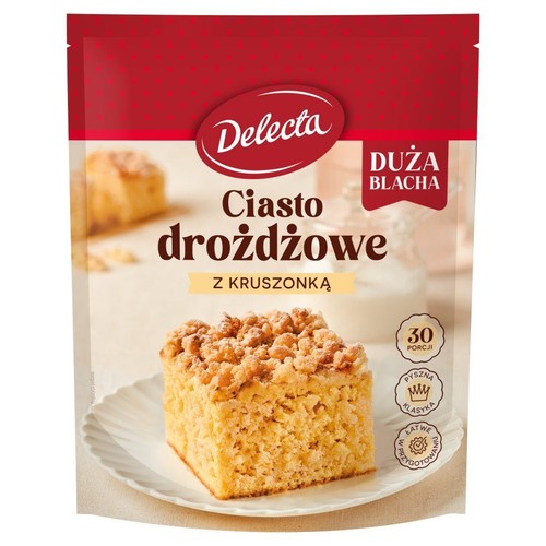 Mieszanka do ciasta drożdżowego Delecta z kruszonką. Czerwono-białe opakowanie z grafiką ciasta. Duża blacha, 30 porcji.