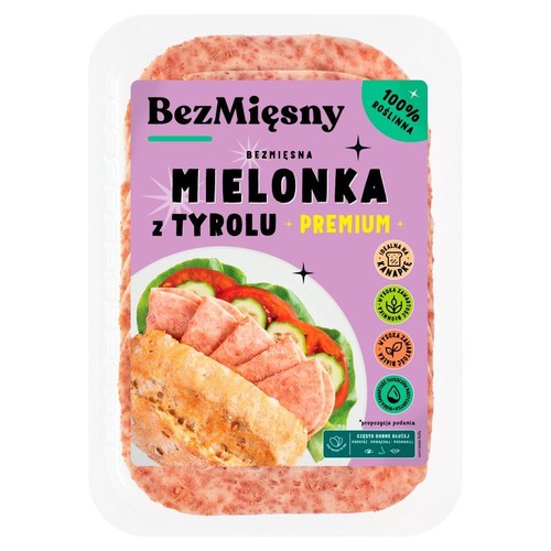 Przezroczyste opakowanie z bezmięsną mielonką, 100% roślinną. Widoczne różowe plastry produktu. Fioletowa etykieta.