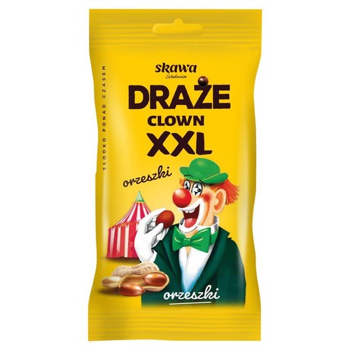 Żółte opakowanie draży Skawa Draże Clown XXL Orzeszki. Na froncie wesoły klaun w zielonym kapeluszu i muszce, trzymający orzeszka ziemnego. Obok niego leżą orzeszki w łupinach. W tle czerwono-biały namiot cyrkowy.