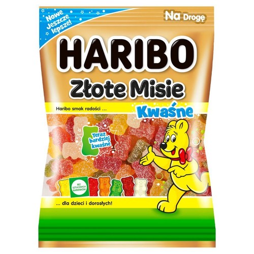 Złota torebka Haribo Złote Misie Kwaśne, z grafiką uśmiechniętego misia Haribo. W środku widoczne różnokolorowe, kwaśne żelki owocowe. Na opakowaniu informacja "Bez sztucznych barwników" i "Teraz bardziej kwaśne".